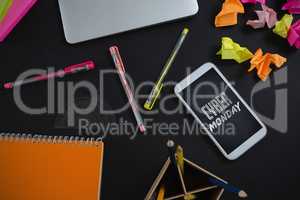 Composite image of laptop, mobile phone and stationery on black background