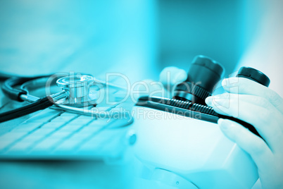 Composite image of close-up of keyboard with stethoscope