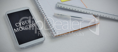 Composite image of mobile phone and stationery on white background