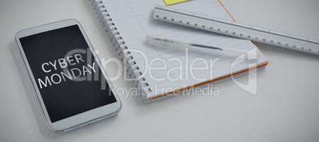 Composite image of mobile phone and stationery on white background