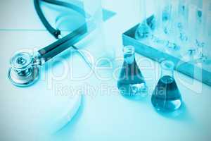 Composite image of stethoscope on desk