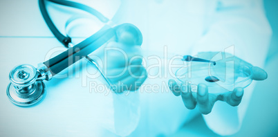 Composite image of stethoscope on desk