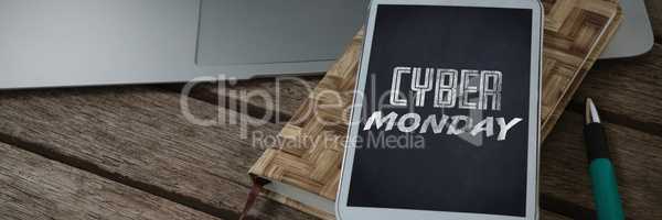 Composite image of laptop, mobile phone, dairy and pen on wooden plank
