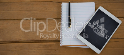 Composite image of blank notepad and digital tablet on wooden plank