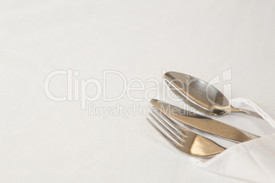 Fork, butter knife and spoon in napkin