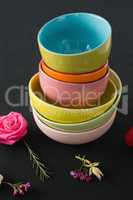 Bowls and flowers arranged on a black themed table