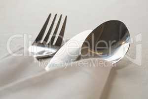 Spoon and fork wrapped in a napkin