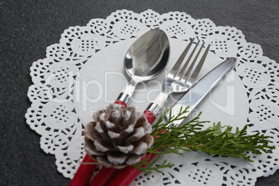 Pine cone with cutlery on a placemat