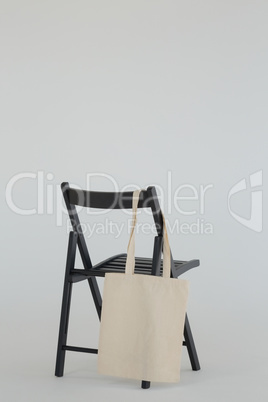 Grocery bag hanging on black chair