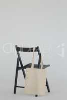 Grocery bag hanging on black chair