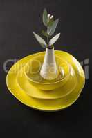 Flower vase kept on porcelain crockery
