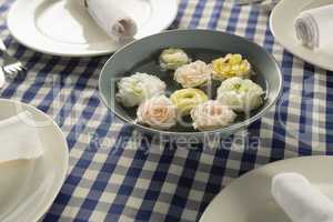Rolled up napkin with flower decoration arranged on table