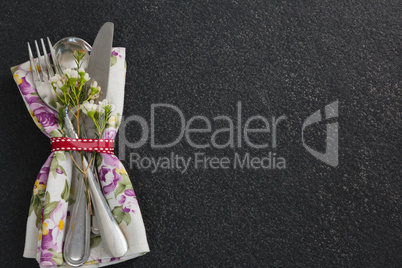 Cutlery with flower and napkin tied with ribbon