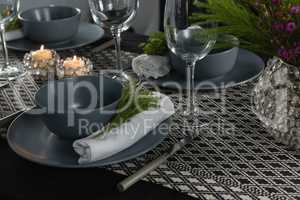 Elegance table setting with empty wine glasses and lit candle