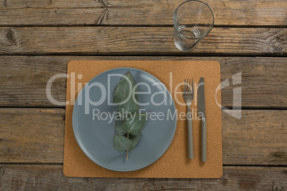 Elegant table setting with leaf and cutlery