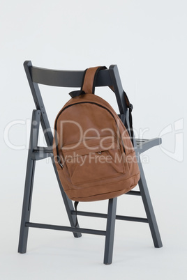 Backpack hanging on black chair