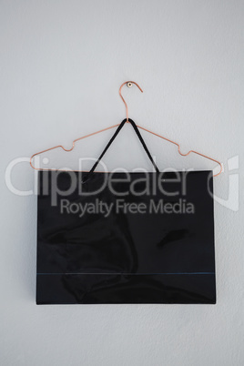 Close-up of shopping bag hanging on wall