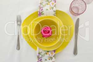 Rose flower in a bowl with cutlery