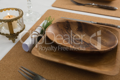Wooden plate and cutlery set on a table