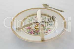 Fork, butter knife, spoon in a plate