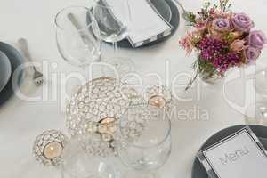 Menu card, plate and cutlery set elegantly on a table