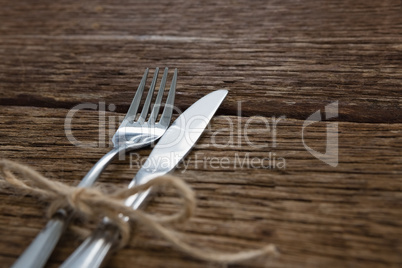 Fork and butter knife tied up with a rope