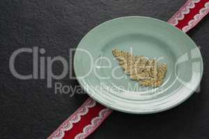 Christmas ornament in a plate with ribbon
