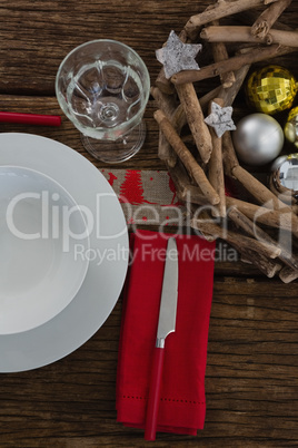 Butter knife, napkin with plate, glass and christmas decoration