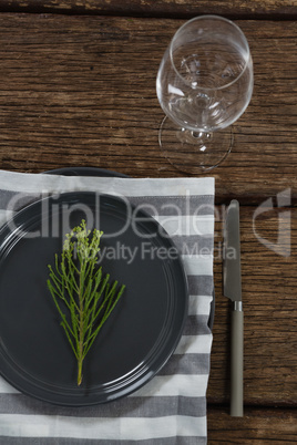 Elegance table setting with empty wine glass on wooden plank