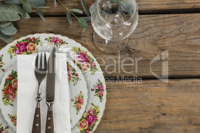 Floral pattern plate with cutlery set and wine glass