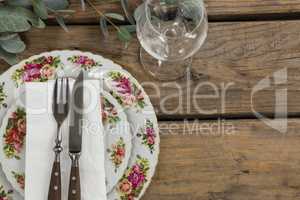 Floral pattern plate with cutlery set and wine glass