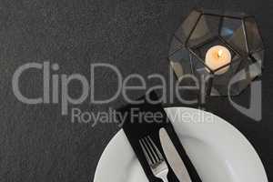 Table setting with lit candle