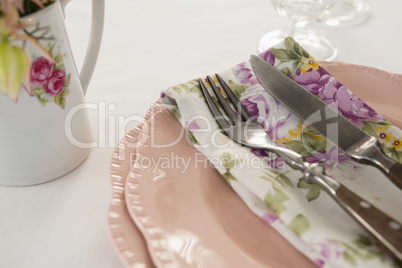 Fork, butter knife and napkin in a plate