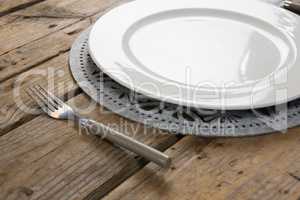 Plate with fork on wooden table
