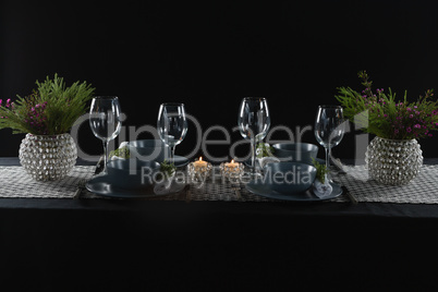 Elegance table setting with empty wine glasses and lit candle