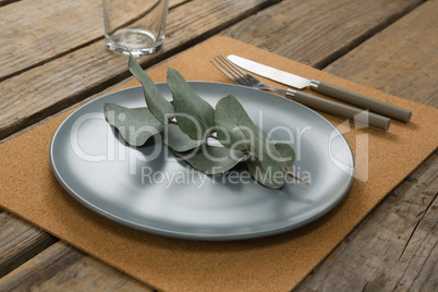 Elegant table setting with leaf and cutlery