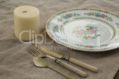 Floral pattern plate with cutlery set and candle