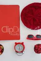 Fruits, file, sunglasses, alarm clock and beanie cap on white background