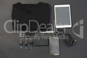 T-shirt, pen, wallet, scissors, usb cable, paper clip, mobile phone and digital tablet on black back