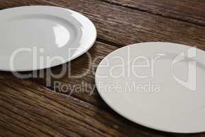 White plates on wooden table