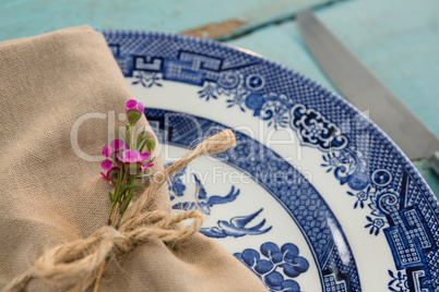 Tied napkin with flora on plate