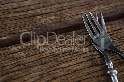 Fork and butter knife on a wooden table