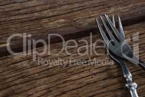 Fork and butter knife on a wooden table