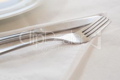 Fork and butter knife on table cloth