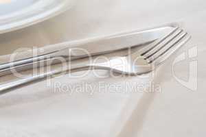 Fork and butter knife on table cloth