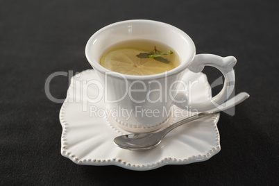 Cup of tea with lemon slice and spoon