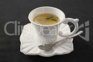 Cup of tea with lemon slice and spoon