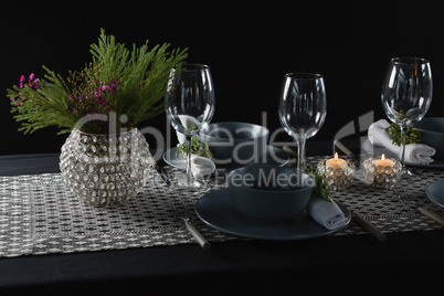 Elegance table setting with empty wine glasses and lit candle