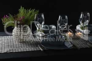 Elegance table setting with empty wine glasses and lit candle