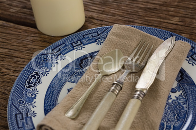 Cutlery and napkin on plate